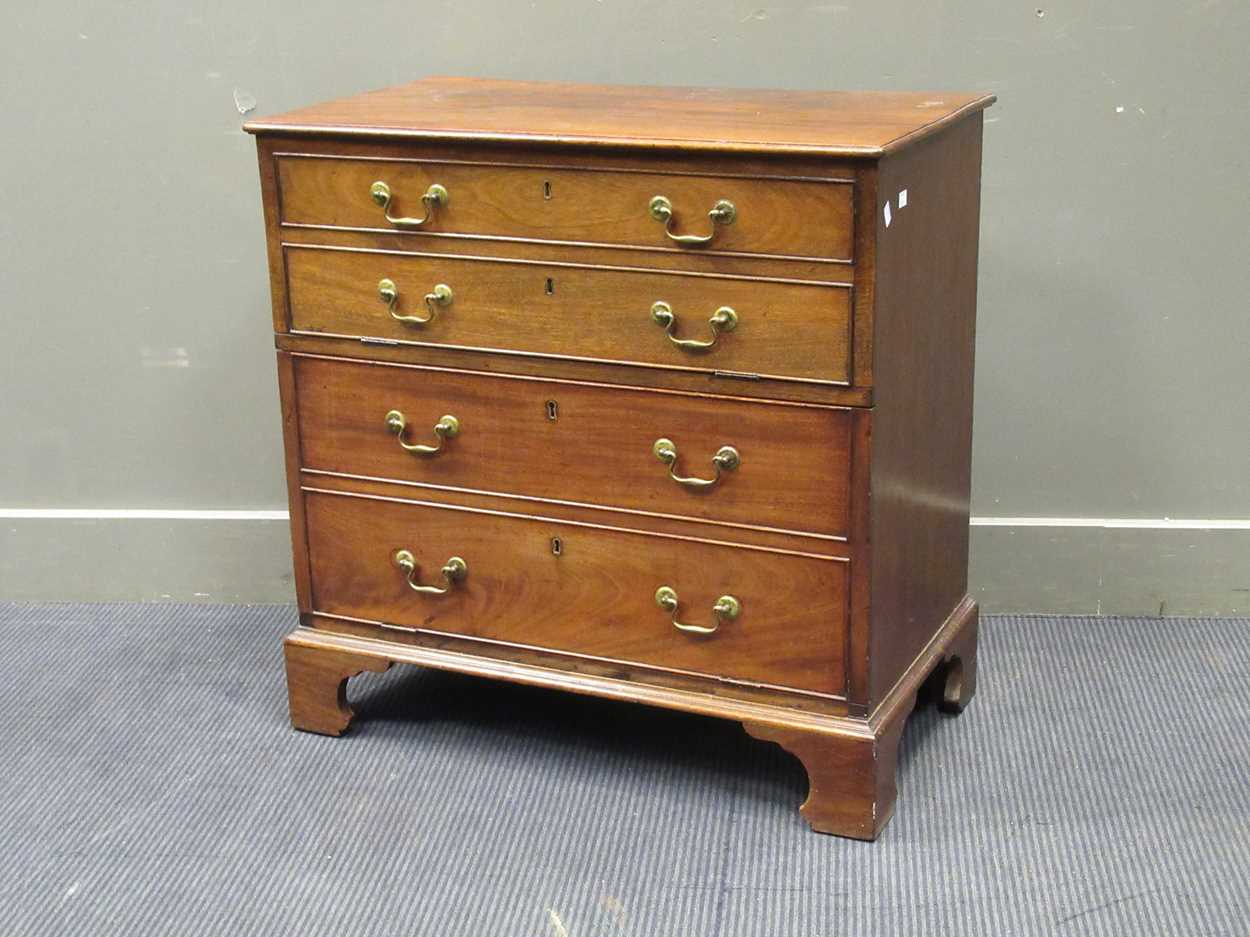 A Georgian style mahogany cabinet, with two fall front cupboard doors hidden by a four faux-drawer