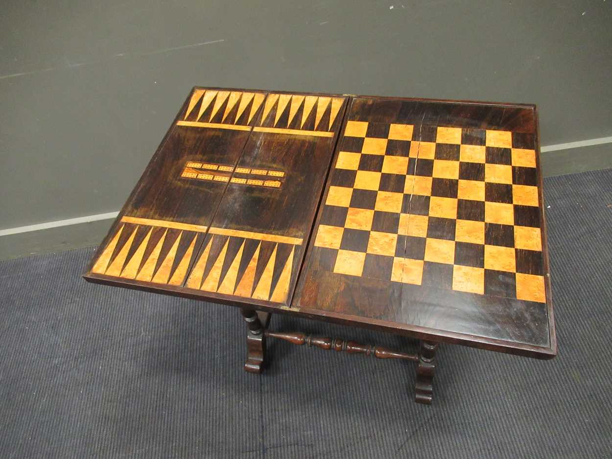 A 19th century inlaid rosewood games table, the fold over swivel top enclosing an inlaid - Image 4 of 10