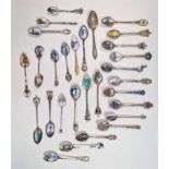 A collection of enamelled teaspoons, mainly European, some of 800/1000 standard silver (9ozt gross),