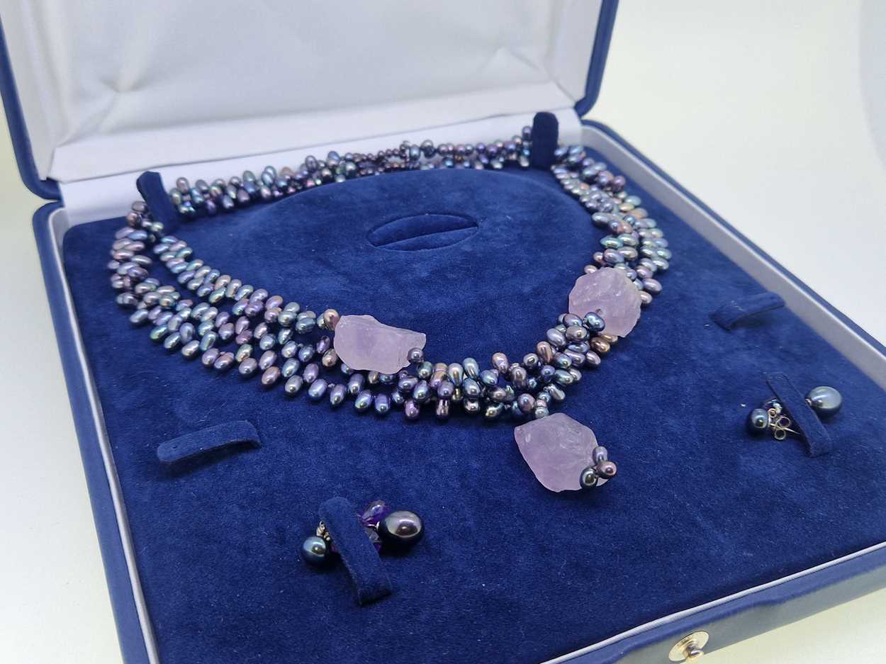 A collection of jewellery to include, an amber pendant, a string of