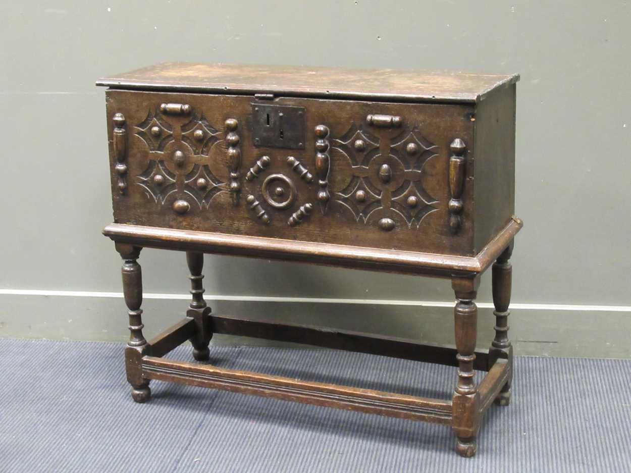 An 18th century oak plank chest on stand, with split baluster decoration, 82 x 93 x 37cm