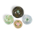A collection of four Perthshire glass swirl paperweights,