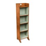 A small Arts and Crafts oak bookcase in the manner of Liberty, circa 1910,