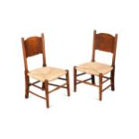 In the manner of William Birch, a pair of stained ash child's chairs,