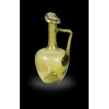 Attributed to Dr Christopher Dresser for Thomas Webb & Sons, an olive green glass ewer, circa 1880,