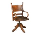 An early 20th century stained oak and elm swivel desk chair,