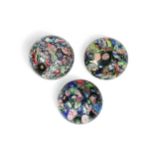 A group of three scrambled millefiori glass paperweights,