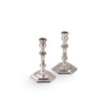 A pair of mid 20th century cast silver candlesticks,