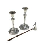 A pair of George V silver candlesticks with a later snuffer,