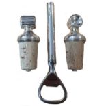 A pair of 20th century silver topped bottle stoppers together with a silver handled bottle opener,