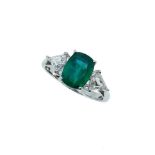 An emerald and diamond three stone ring,