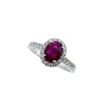 An 18ct gold Burmese ruby and diamond halo style cluster ring,