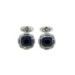 A pair of onyx and diamond cufflinks,