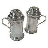 A pair of early 20th century Britannia silver bun top spice casters,