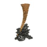 A Chinese carved and pierced rhinoceros horn on stand, Qing Dynasty, circa 1880,