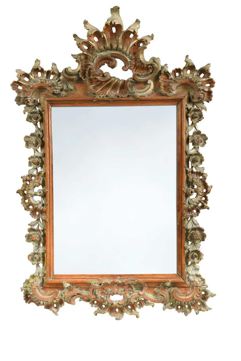 A Continental Rococo carved and part silvered wall mirror, late 18th/early 19th century,