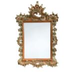 A Continental Rococo carved and part silvered wall mirror, late 18th/early 19th century,