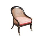 A Regency brass and ebonised bergere armchair,