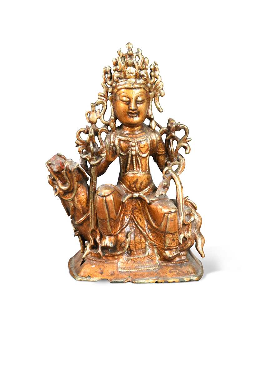 A Chinese gold lacquered bronze figure of a deity, late Ming Dynasty,