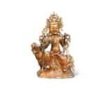 A Chinese gold lacquered bronze figure of a deity, late Ming Dynasty,