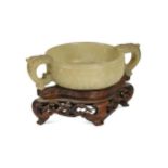 A Chinese jade tab-handled bowl in an archaic style, Qing Dynasty, 19th century,