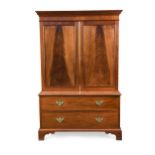 A George III mahogany panelled cupboard on chest,