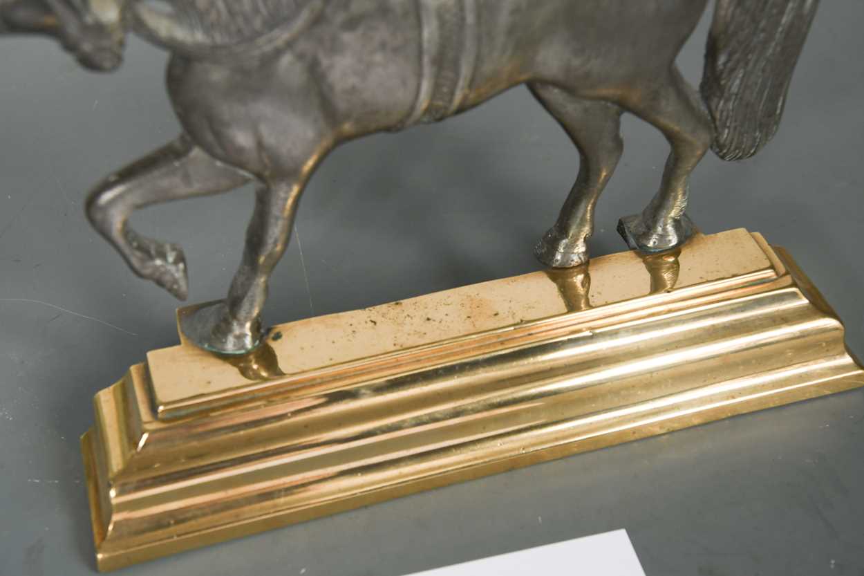 A polished pewter and brass doorstop, 19th century, - Image 4 of 4