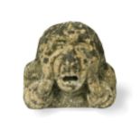 A stone corbel of a man,