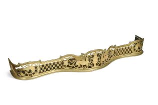 A George III pierced brass fender,