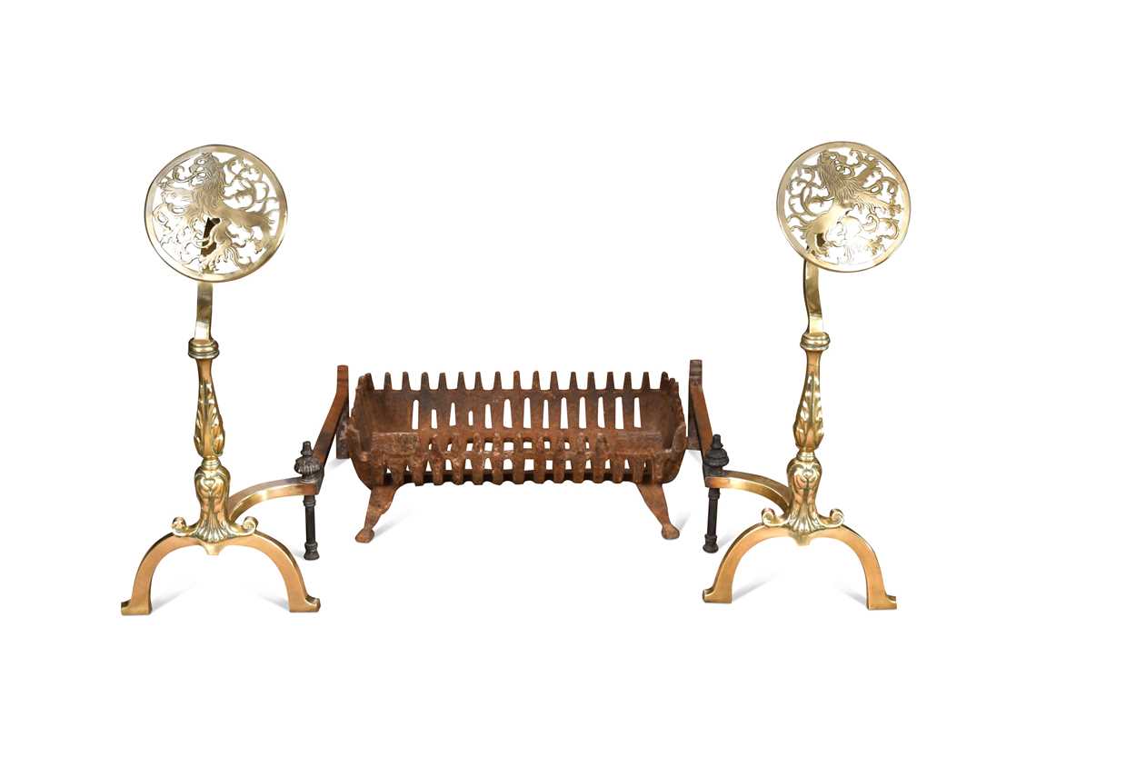 A pair of brass fire dogs and a cast iron basket fire grate, 19th century,