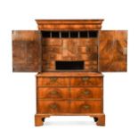 A George I walnut cabinet on chest,