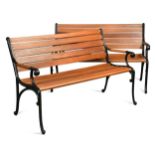 A pair of cast metal and mahogany garden benches, recent construction,