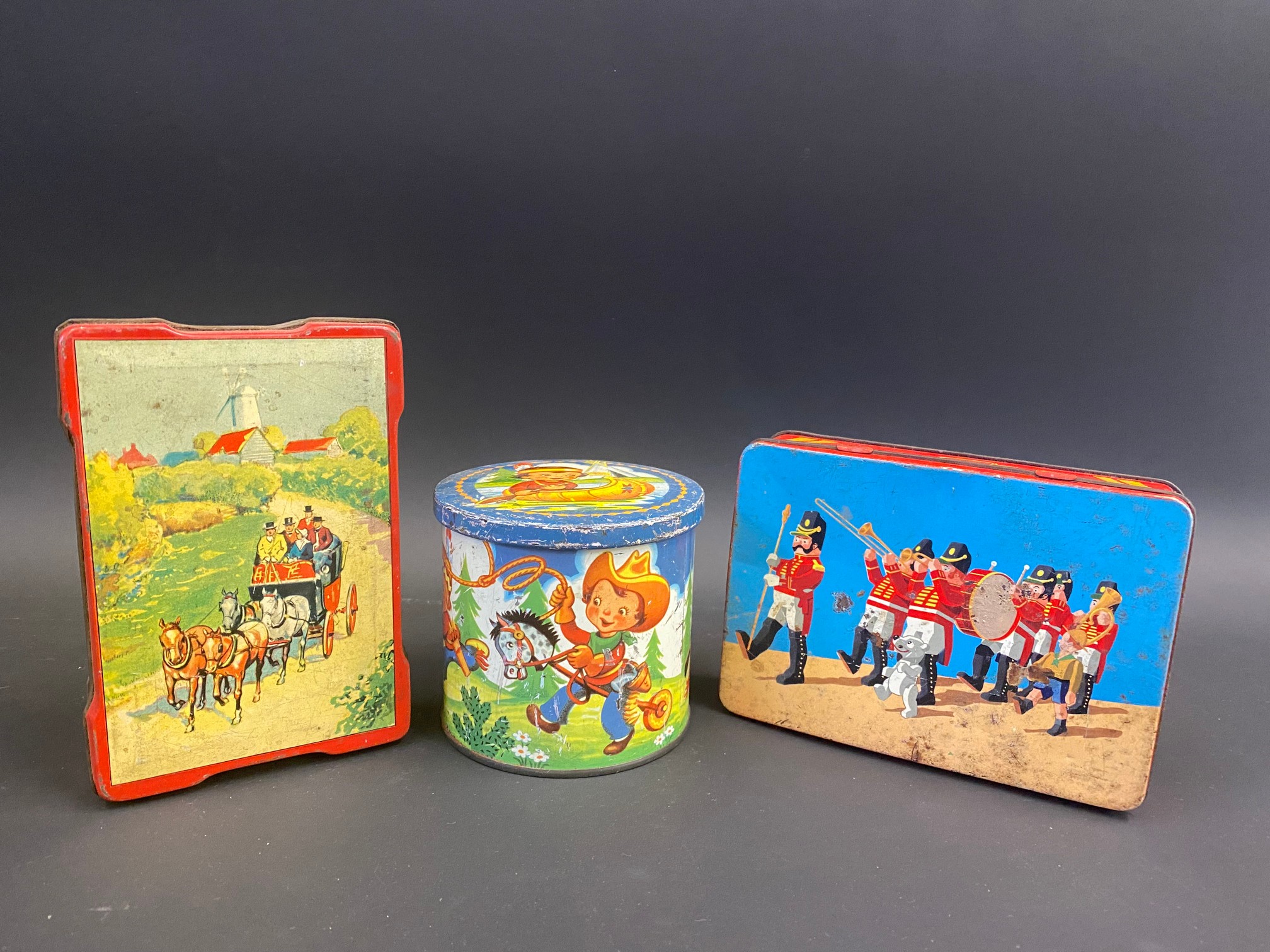 A Blue Bird Confectionery tin decorated with stylised children playing cowboys and indians, a