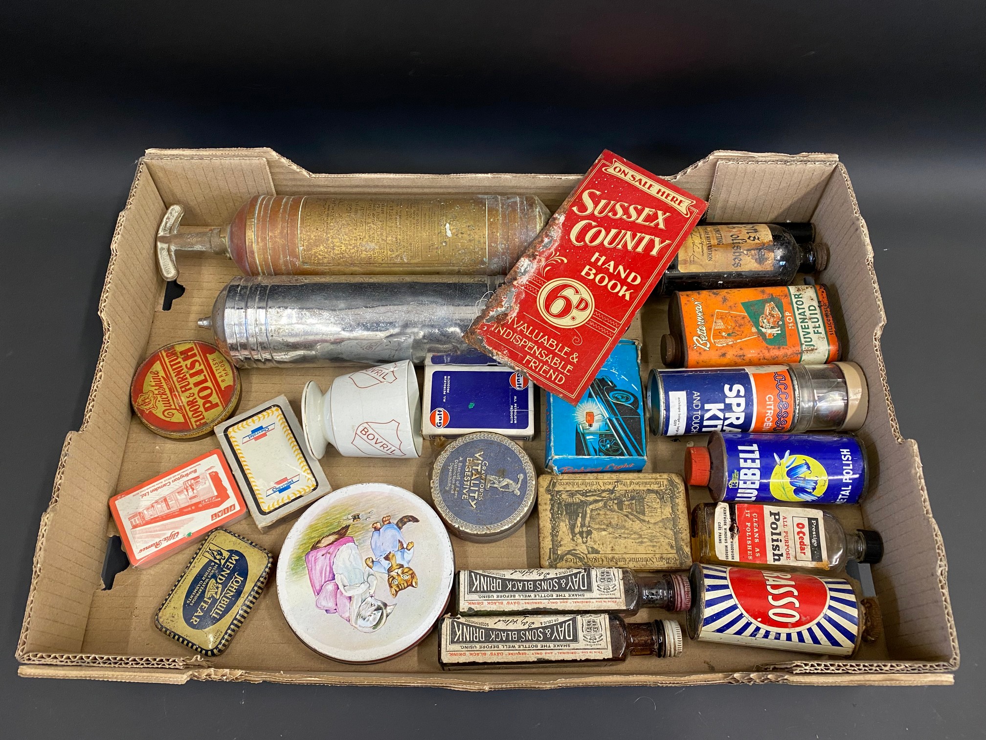 A tray of assorted tins, packaging, automobilia and advertising items, including a small Sussex