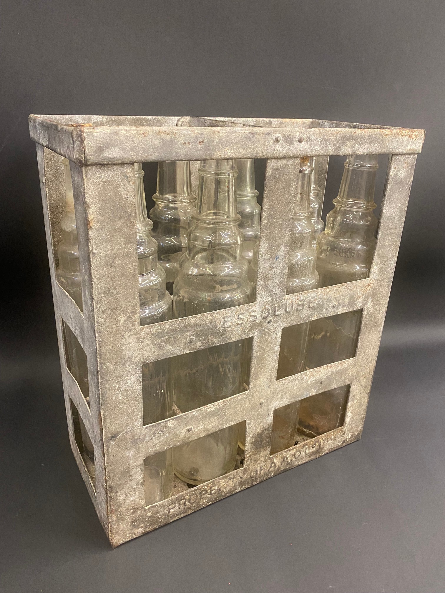 An Essolube eight division oil bottle crate containing a full set of quart oil bottles.