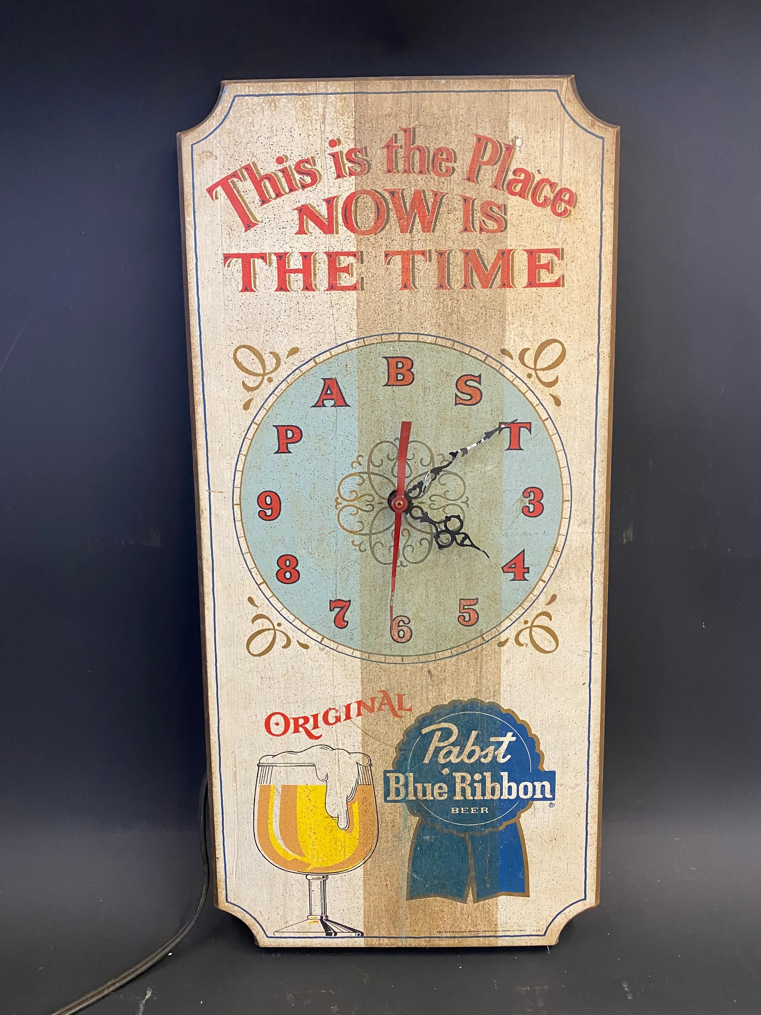 A painted wooden American wall clock, 11 1/2 x 24".