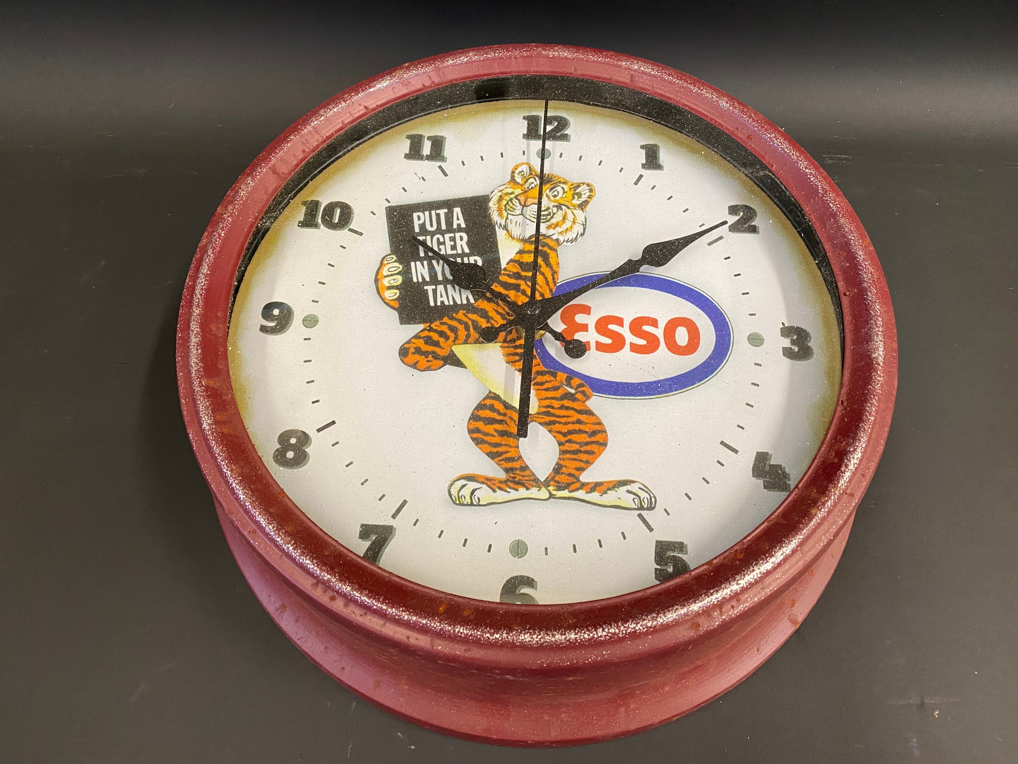 A reproduction garage battery operated wall clock, decorated to the dial with an Esso 'Tiger in your