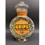 A Grips First-aid Pastilles glass dispensing jar of circular shape, with contents and lid, 13" h.