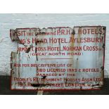 A large enamel sign advertising The King's Head Hotel, Aylesbury and the Norman Cross Hotel,