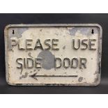 An aluminium sign bearing the words 'Please Use Side Door', 17 x 11".