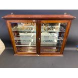 An original Cadbury's wall hanging front opening two door display cabinet, by O.C.Hawkes, stamped