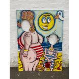 A large fairground/seaside amusement hand painted panel with two oval cut-out holes for heads to
