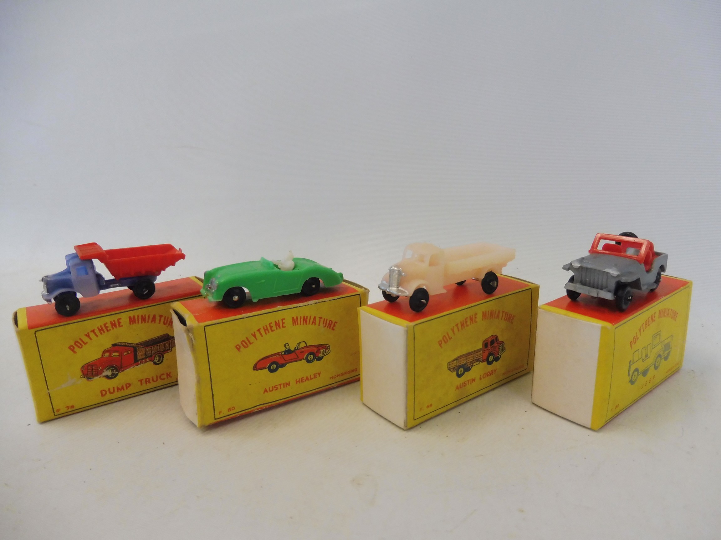 Four boxed Made in Hong Kong early polythene miniatures, an Austin Healey, a Jeep, an Austin lorry