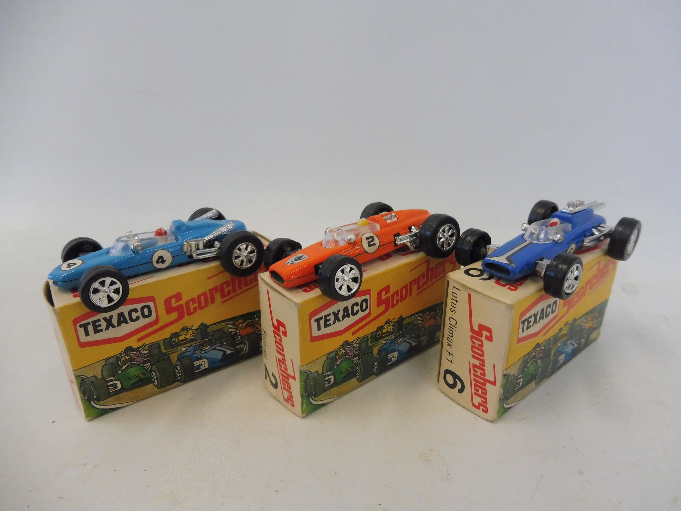 Three Texaco Scorchers in excellent condition, no.6 Lotus Climax, no.2 Ferrari and a no.4 Eagle.