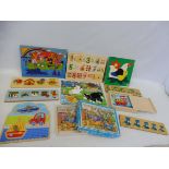 A selection of wooden jigsaw puzzles, some contemporary and some older examples.