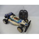 A Tamiya Striker 58061 1/10th scale electric remote controlled buggy circa 1987, plastic tub and