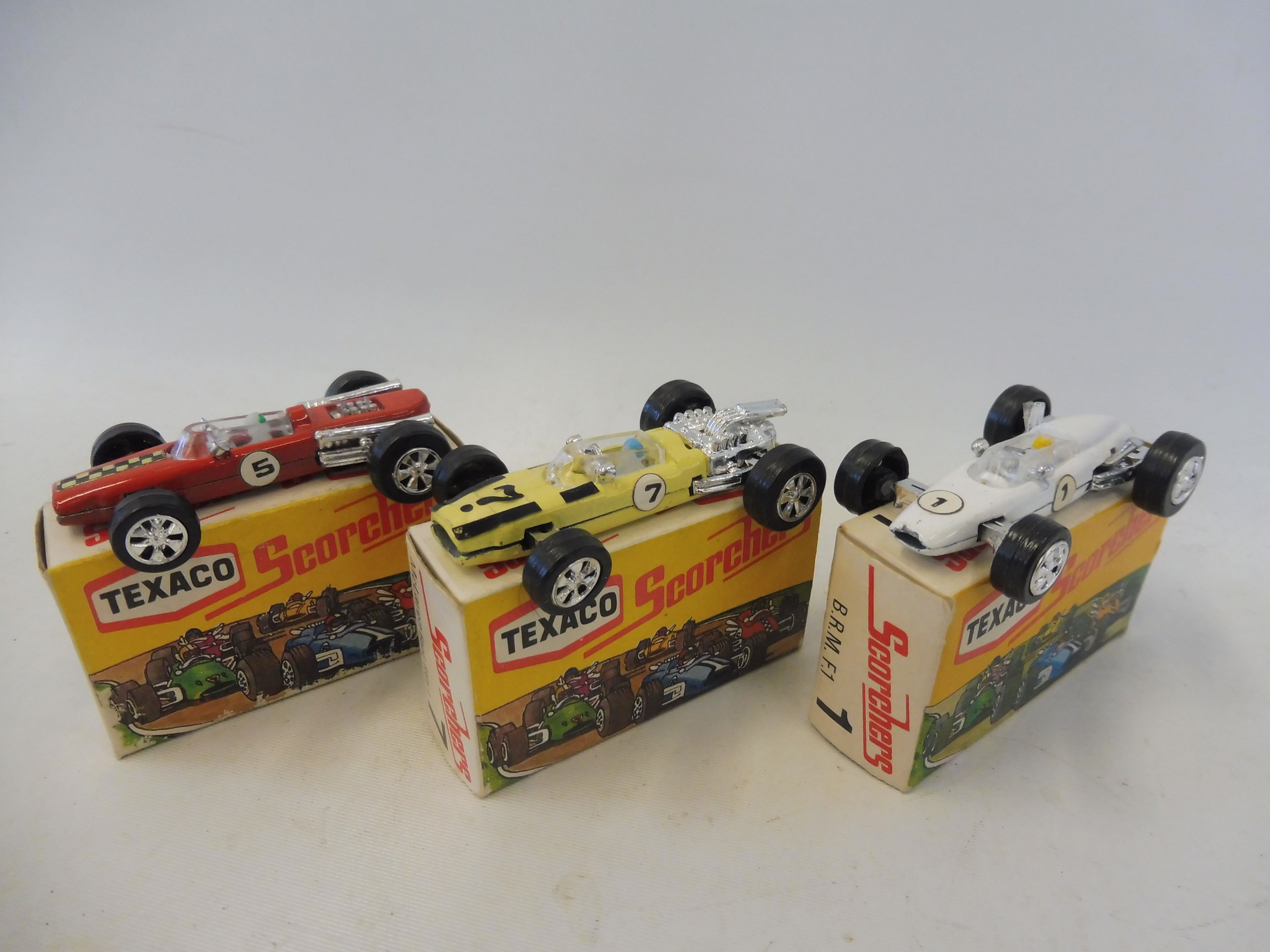 Three Texaco Scorchers in excellent condition, no.1 BRM, a no.7 McLaren Ford and a no.5 Brabbham