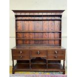 An early 19th Century oak dresser, the base with five drawers above a pot board, all below a plate