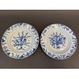 A pair of Chinese blue and white plates decorated with a vase of flowers to the centre, 19th Century
