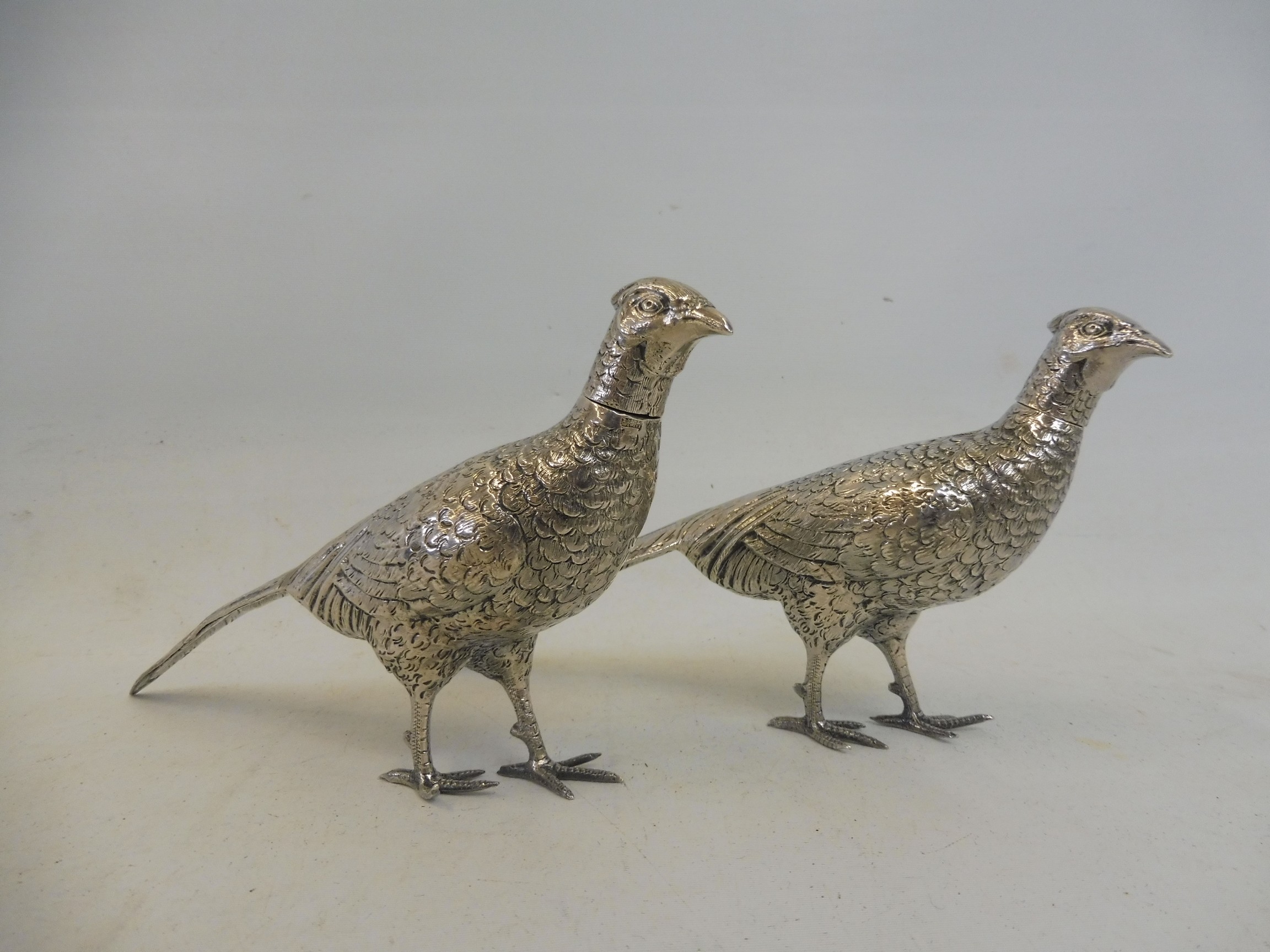 A pair of sterling silver pheasants, with removable heads, import hallmarks.